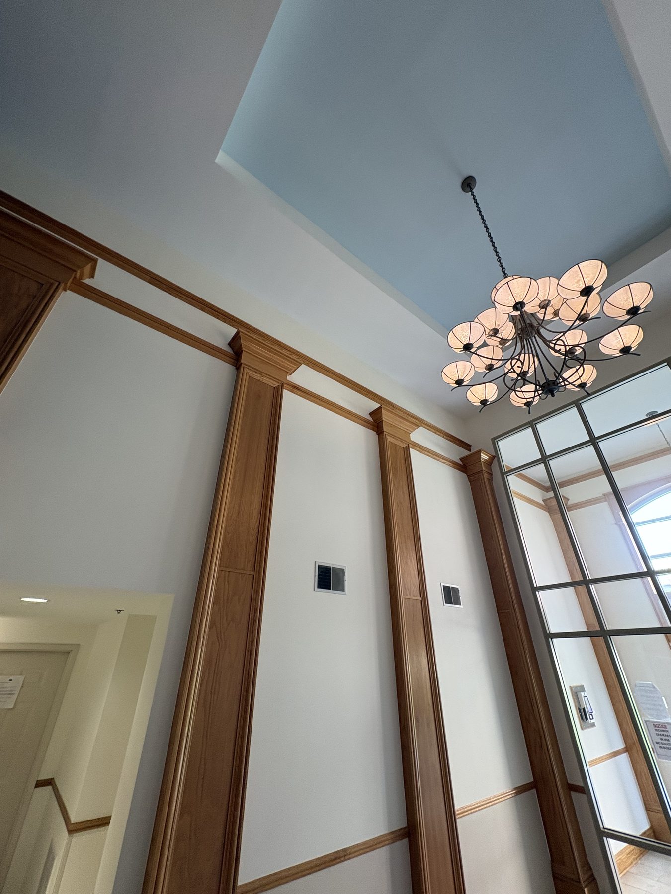 Grand lobby ceiling with blue tray and wood pilasters