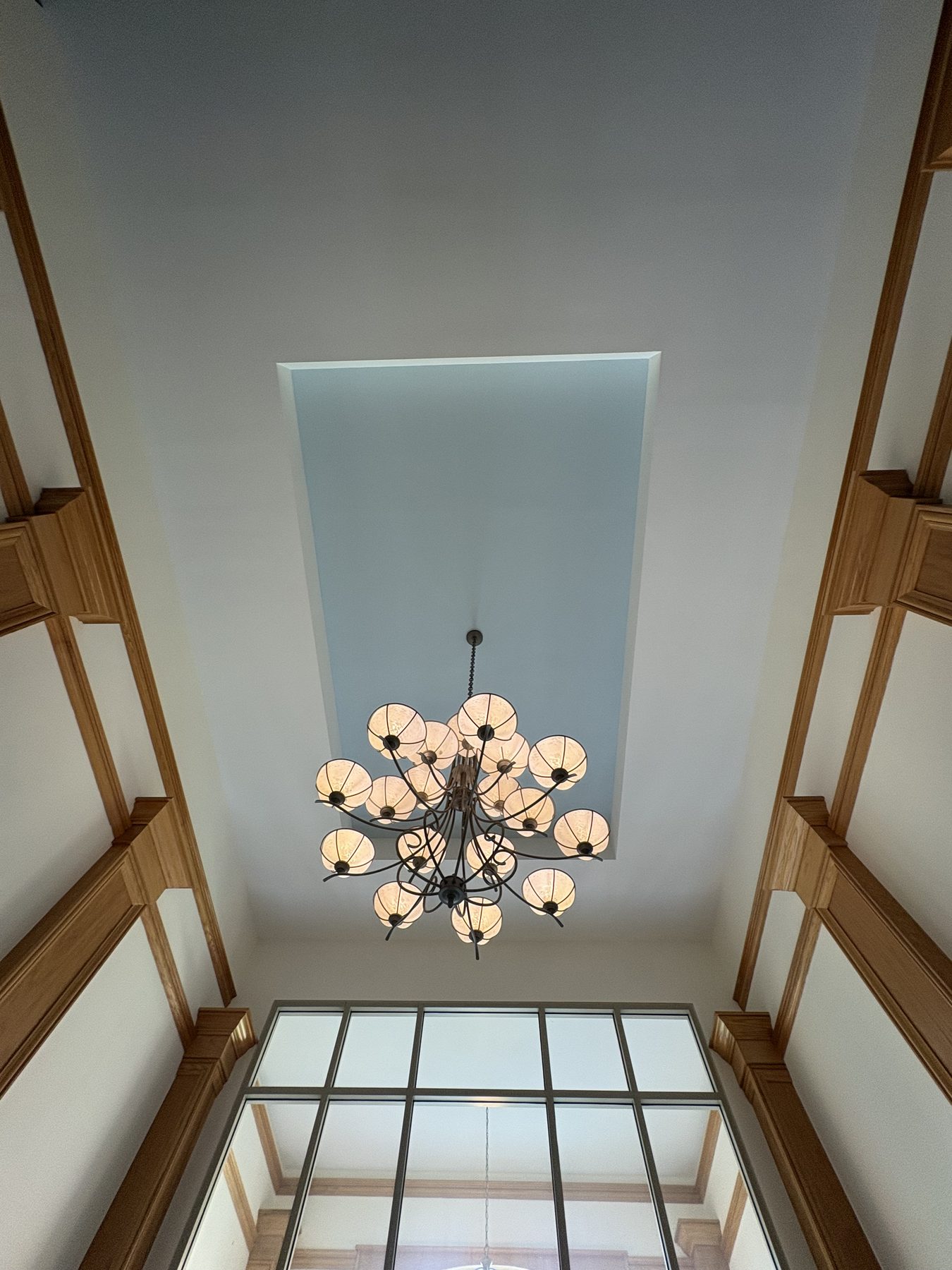 Chandelier and wood pilaster ceiling detail