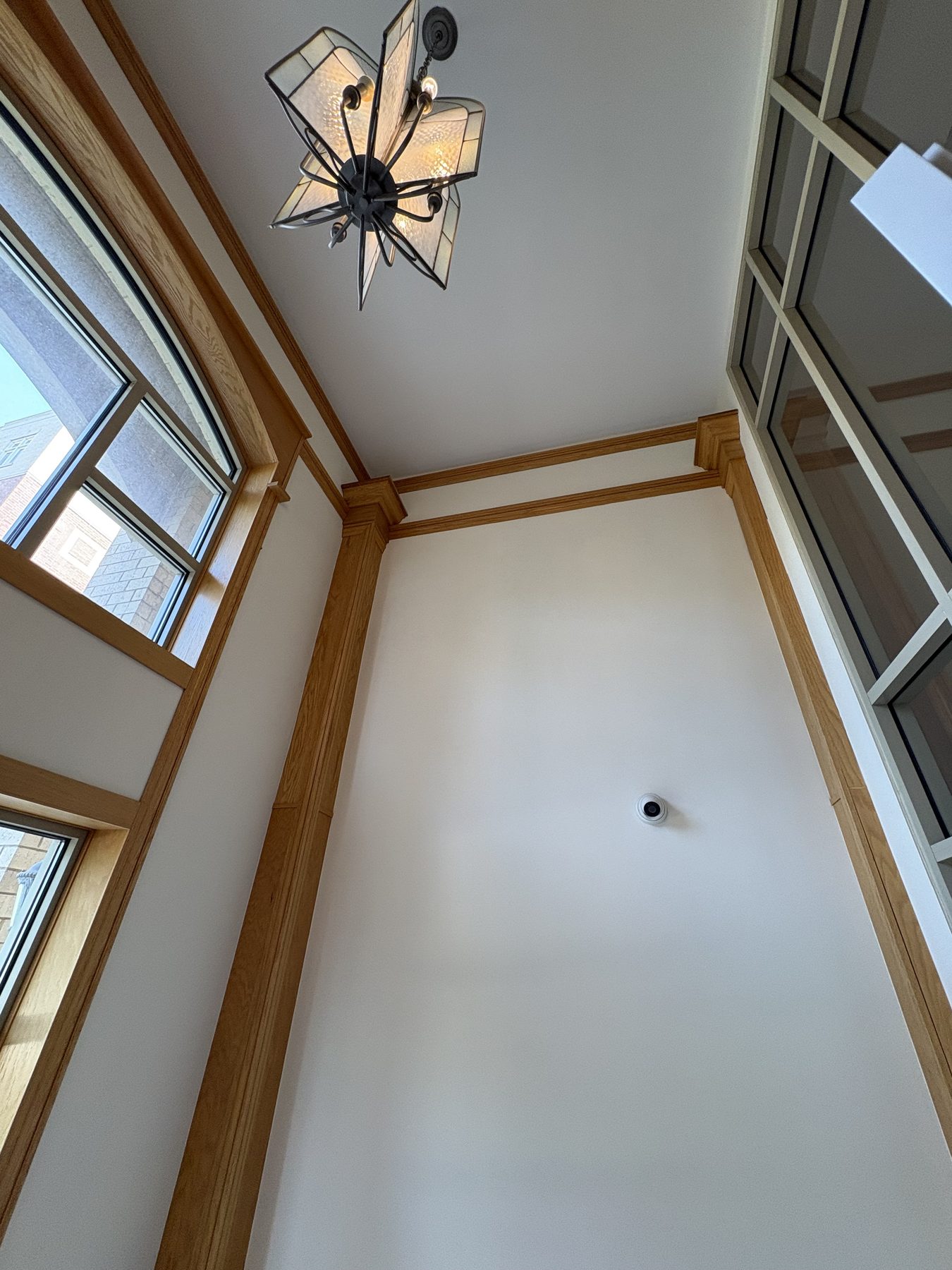 High ceiling entry with wood trim