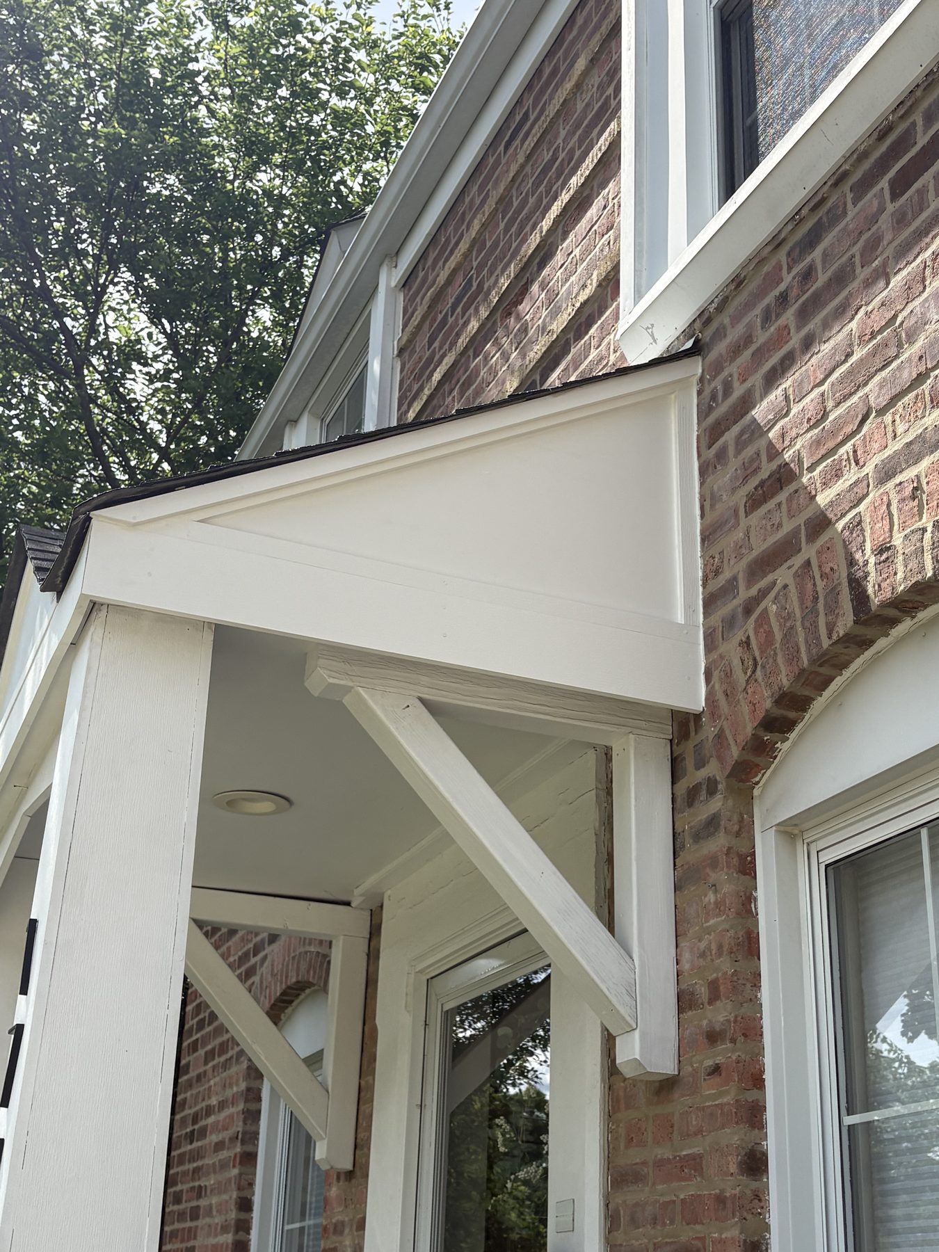 Crisp white portico and trim on brick home